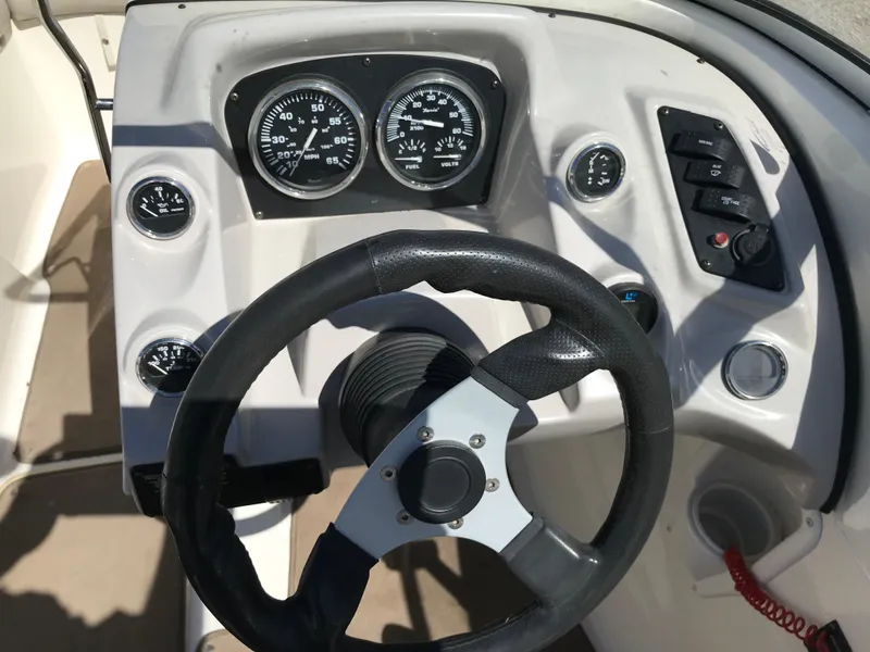 Slide: The Image of 2005 Larson Senza 186 I/O boat dashboard with steering wheel and gauges. - 8