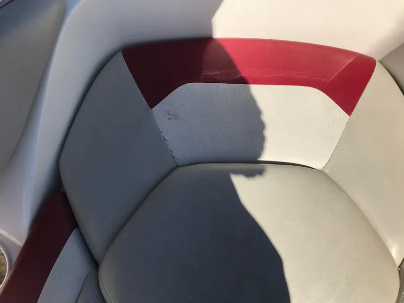 Slide: The Image of 2005 Larson Senza 186 I/O boat seat with red and gray upholstery. - 9