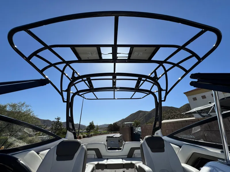 Slide: The Image of 2016 Yamaha Boats 242 Limited E-Series with sleek black framework under clear blue sky. - 12