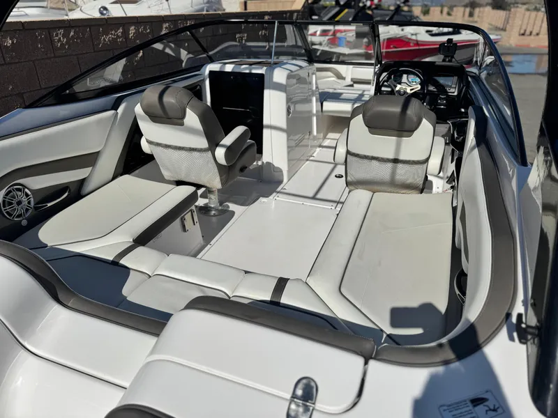 Slide: The Image of 2016 Yamaha Boats 242 Limited E-Series interior with sleek seating and modern dashboard. - 13
