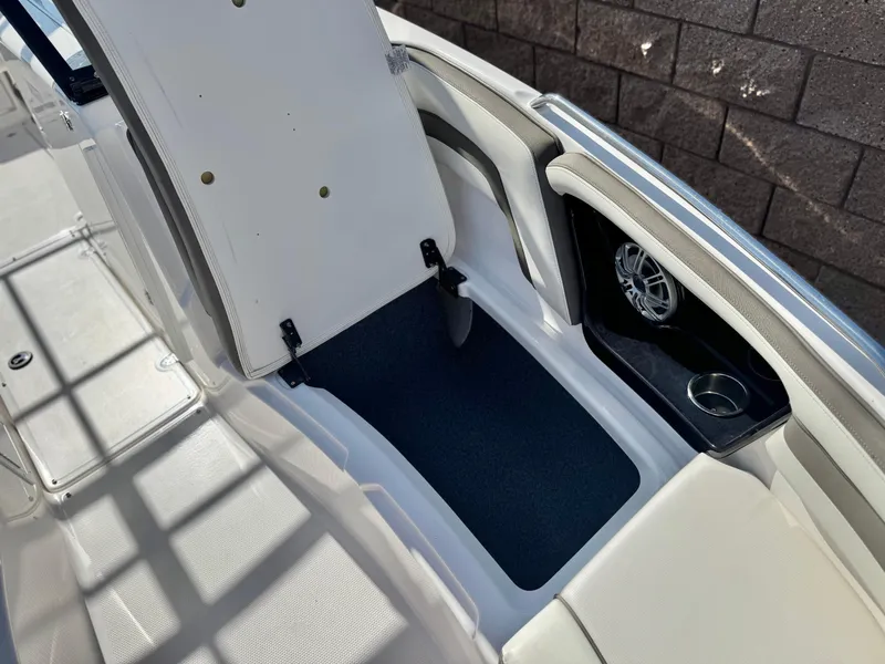Slide: The Image of 2016 Yamaha Boats 242 Limited E-Series interior storage compartment with speaker and cup holder. - 18