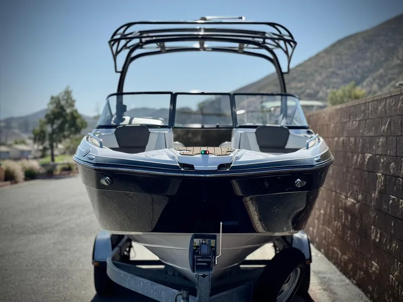 Slide: The Image of 2016 Yamaha Boats 242 Limited E-Series on trailer, parked outdoors with scenic mountain backdrop. - 2