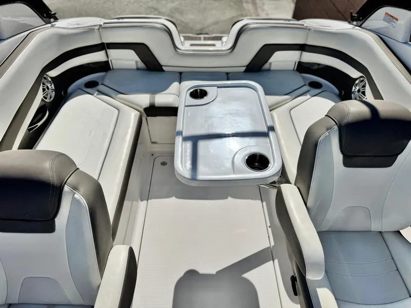 Slide: The Image of 2016 Yamaha Boats 242 Limited E-Series interior with seating and table, featuring cup holders. - 23
