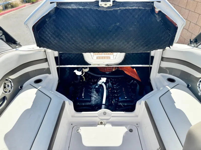 Slide: The Image of 2016 Yamaha Boats 242 Limited E-Series engine compartment with open hatch, showcasing dual engines. - 24