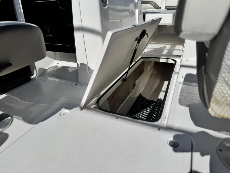 Slide: The Image of 2016 Yamaha Boats 242 Limited E-Series open storage compartment on deck. - 26