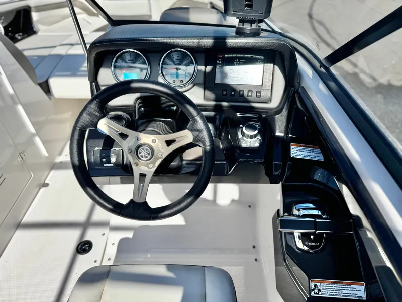 Slide: The Image of 2016 Yamaha Boats 242 Limited E-Series dashboard with steering wheel and controls. - 31