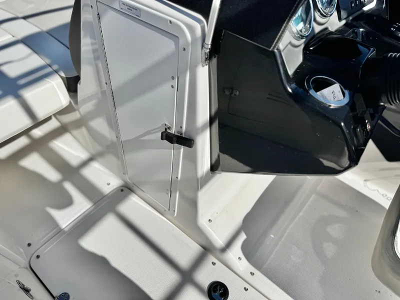 Slide: The Image of 2016 Yamaha Boats 242 Limited E-Series cockpit with control panel and storage compartment. - 34