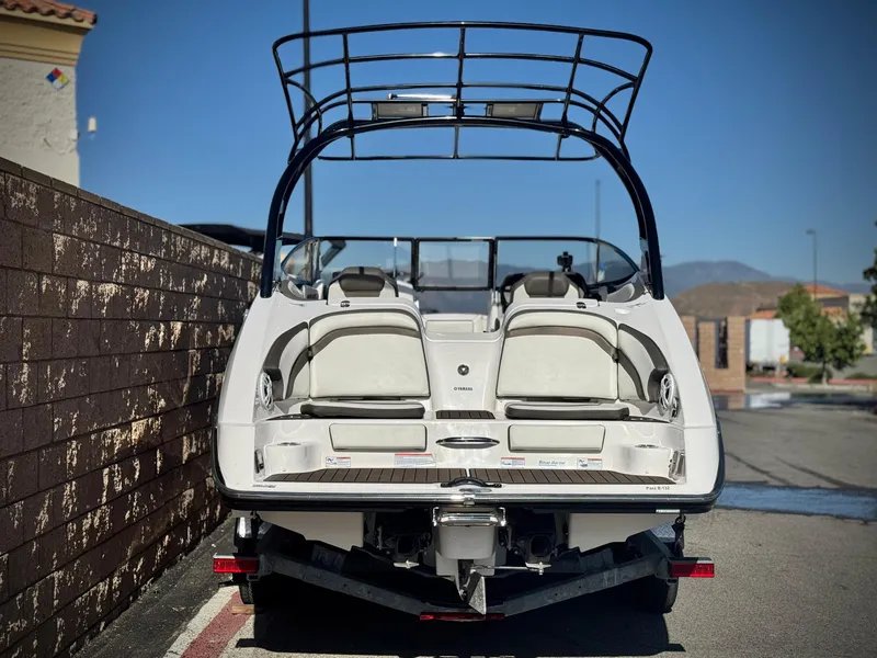 Slide: The Image of 2016 Yamaha Boats 242 Limited E-Series, rear view, parked outdoors. - 4