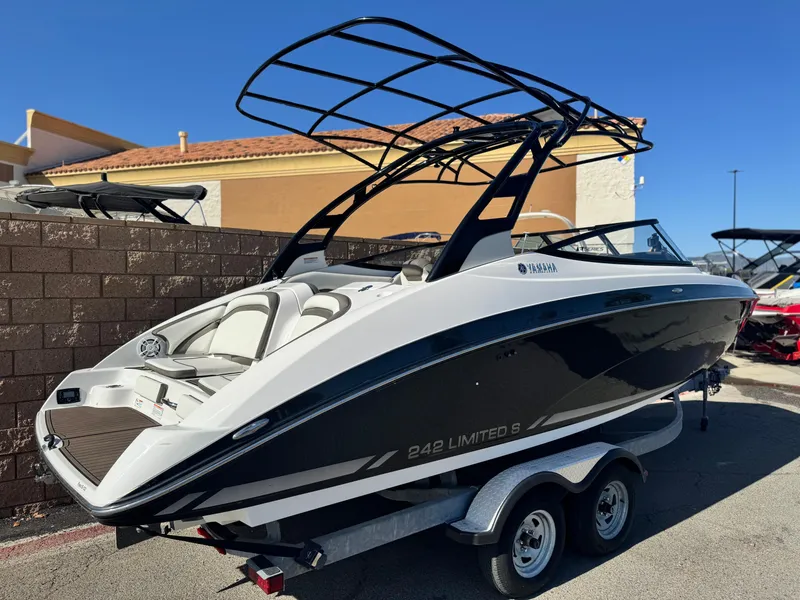 Slide: The Image of 2016 Yamaha Boats 242 Limited E-Series on trailer, sleek black and white design. - 5