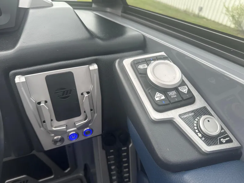 Slide: The Image of Control panel of a 2022 Malibu M220 boat, featuring modern buttons and dials. - 10