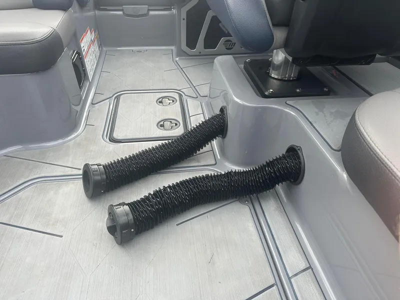 Slide: The Image of 2022 Malibu M220 boat interior with flexible air ducts on the floor. - 16