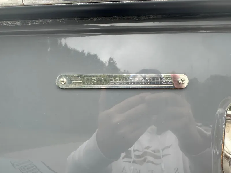 Slide: The Image of 2022 Malibu M220 identification plate with serial number on a gray surface. - 18