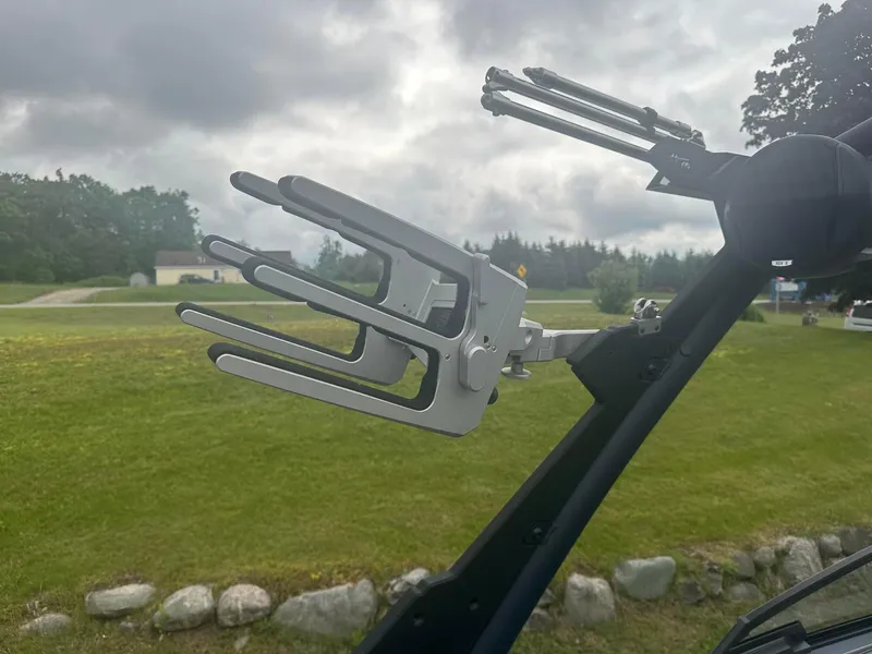 Slide: The Image of Wakeboard rack on 2022 Malibu M220 boat against cloudy sky. - 19