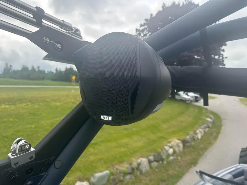 Slide: The Image of 2022 Malibu M220 boat speaker on a metal frame, outdoor setting. - 20