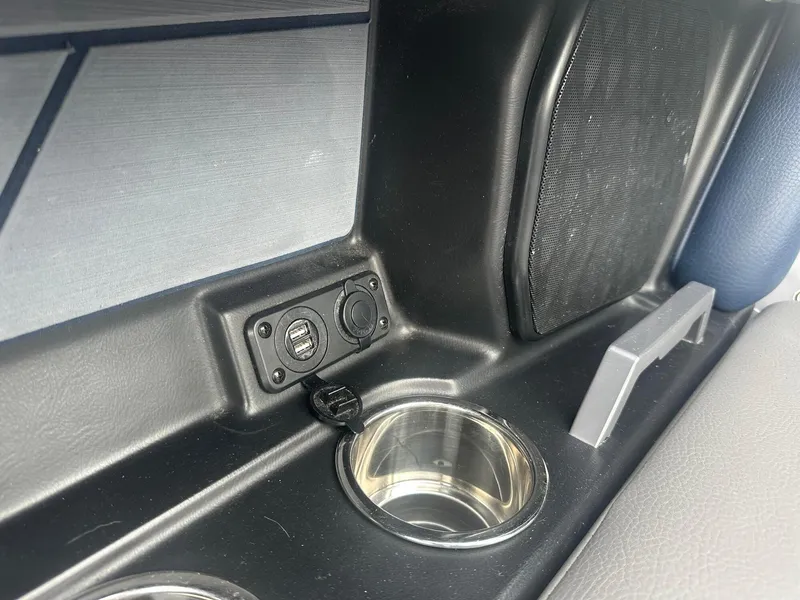 Slide: The Image of Interior of 2022 Malibu M220 featuring USB ports and cup holders. - 21