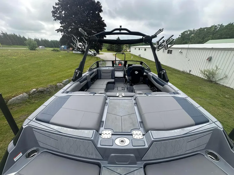 Slide: The Image of 2022 Malibu M220 boat interior with spacious seating and sleek design. - 33