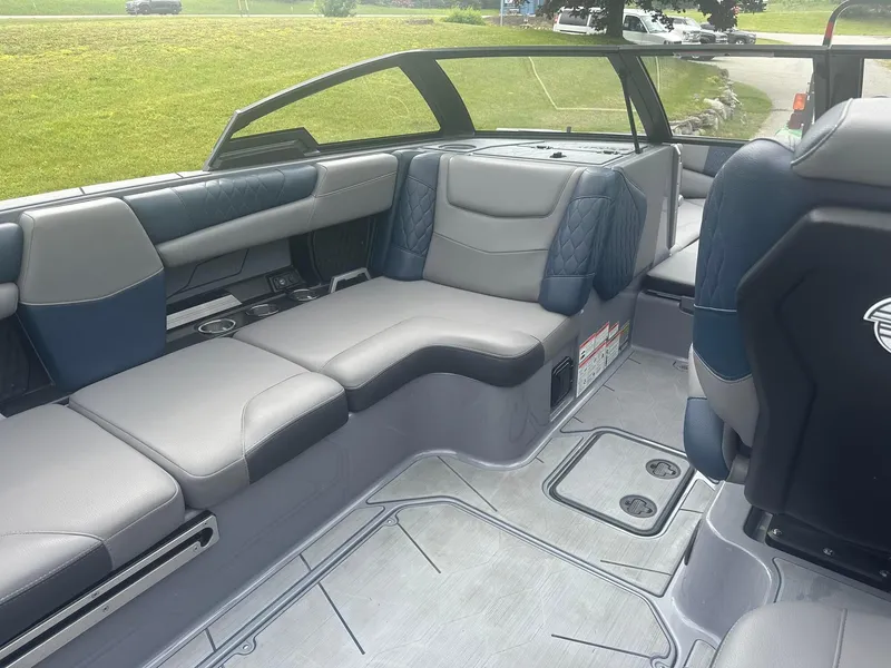 Slide: The Image of 2022 Malibu M220 boat interior with luxurious seating and modern design. - 34