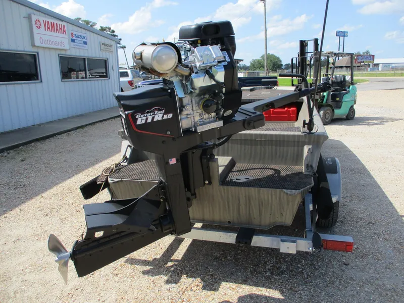 Slide: The Image of Gator Tail 2048 EXTREME 2025 boat motor on trailer outside dealership. - 3