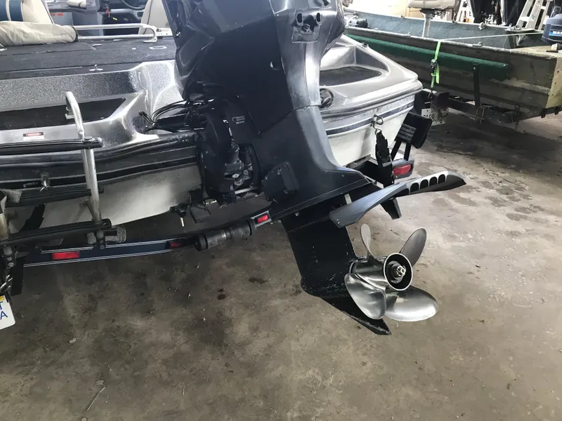 Slide: The Image of Rear view of a 1994 ProCraft COMBO 200 boat with an outboard motor. - 11