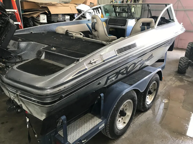 Slide: The Image of 1994 ProCraft COMBO 200 boat on trailer in a garage setting. - 13