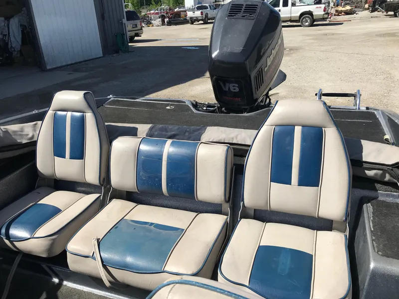 Slide: The Image of 1994 ProCraft COMBO 200 boat interior with blue and beige seating and V6 engine. - 17