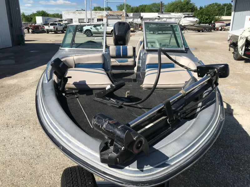 Slide: The Image of 1994 ProCraft COMBO 200 boat with dual windshields and seating, parked outdoors. - 23