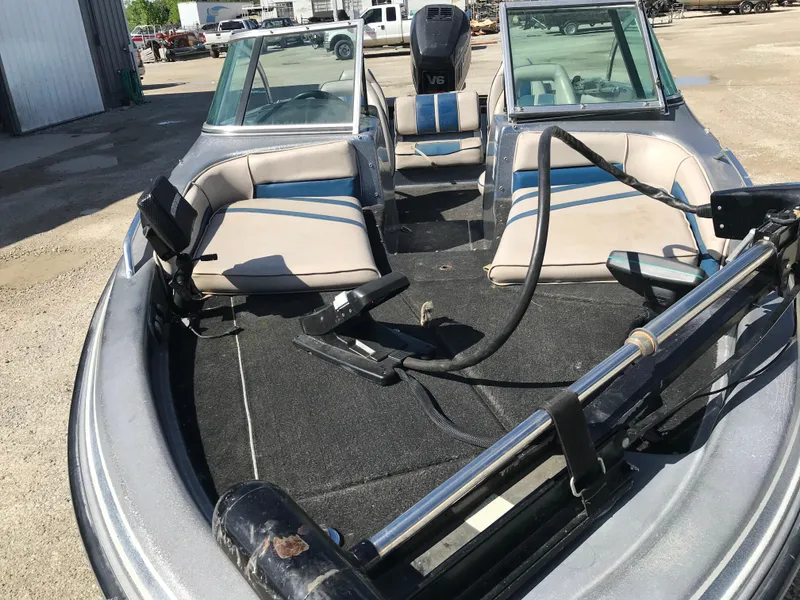 Slide: The Image of 1994 ProCraft COMBO 200 boat interior with seating and equipment, parked outdoors. - 28