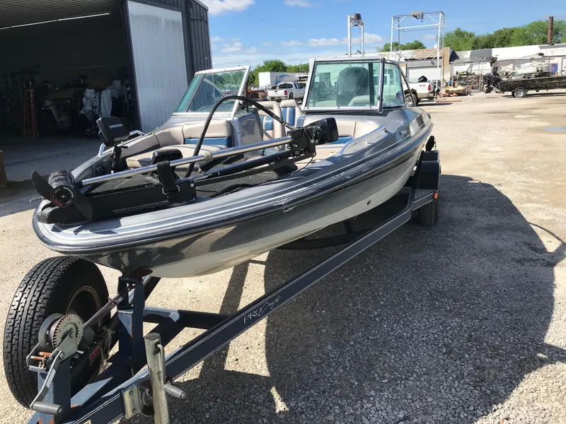 Slide: The Image of 1994 ProCraft COMBO 200 boat on trailer, parked outdoors under clear sky. - 29