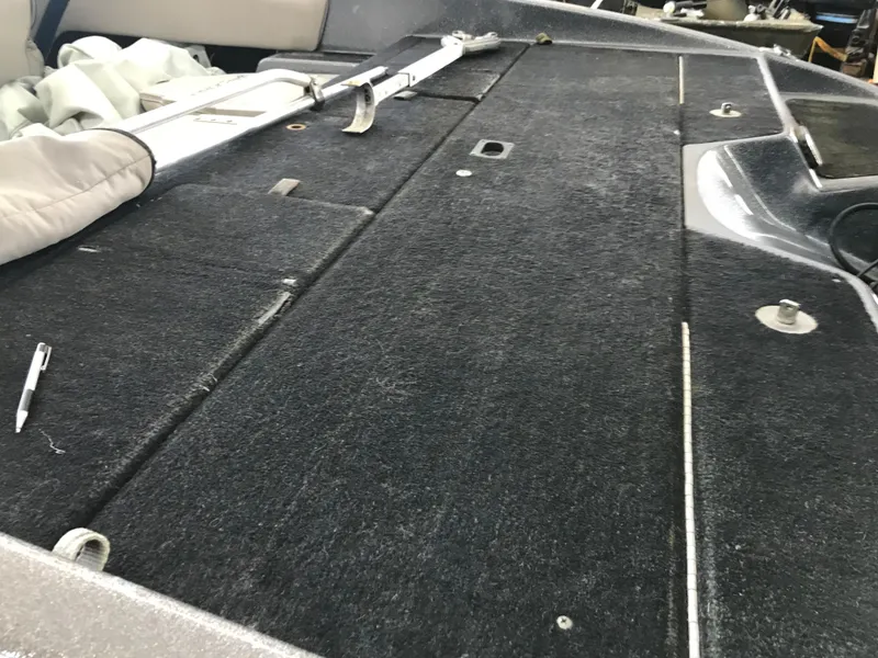 Slide: The Image of 1994 ProCraft COMBO 200 boat deck with black carpet and storage compartments. - 9