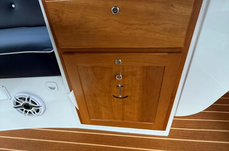 Slide: The Image of Wooden cabinet with anchor handle on 2022 Duffy 22 Sun Cruiser boat interior. - 12