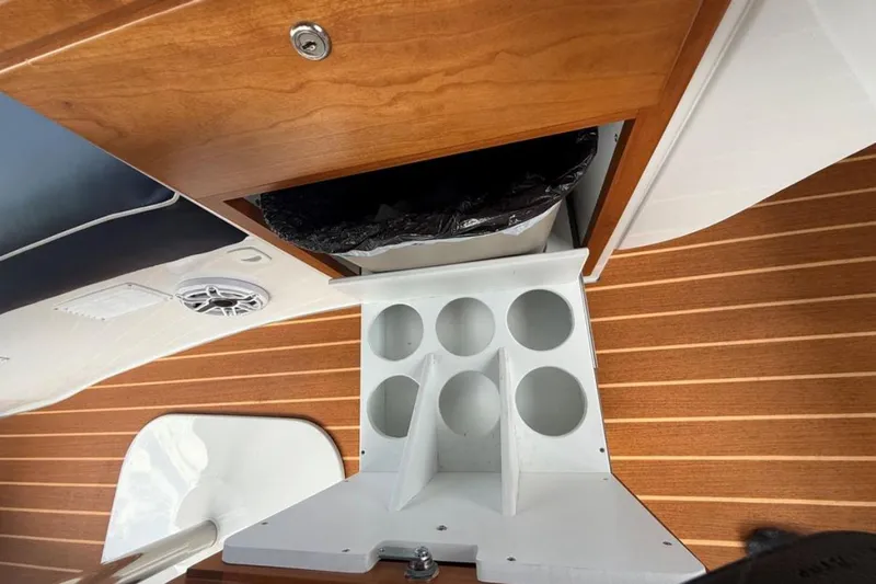 Slide: The Image of 2022 Duffy 22 Sun Cruiser interior with cup holders and wooden cabinetry. - 15