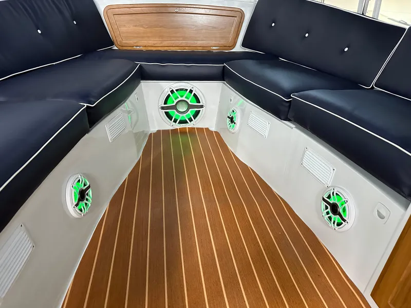 Slide: The Image of Interior of 2022 Duffy 22 Sun Cruiser with wood flooring and cushioned seating. - 18