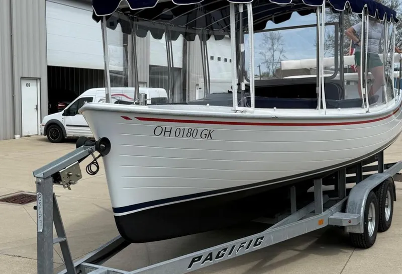 Slide: The Image of 2022 Duffy 22 Sun Cruiser on trailer, parked outside a building. - 2