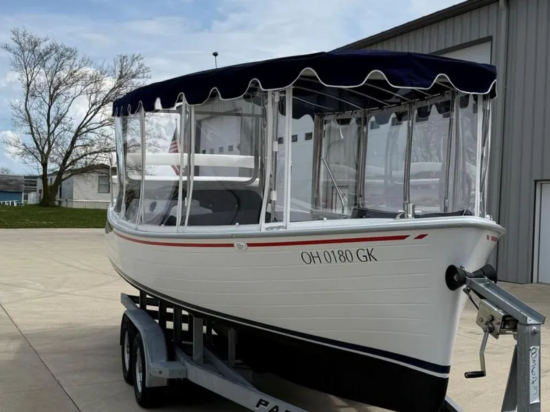 Slide: The Image of 2022 Duffy 22 Sun Cruiser boat on trailer, with canopy and clear side panels. - 4