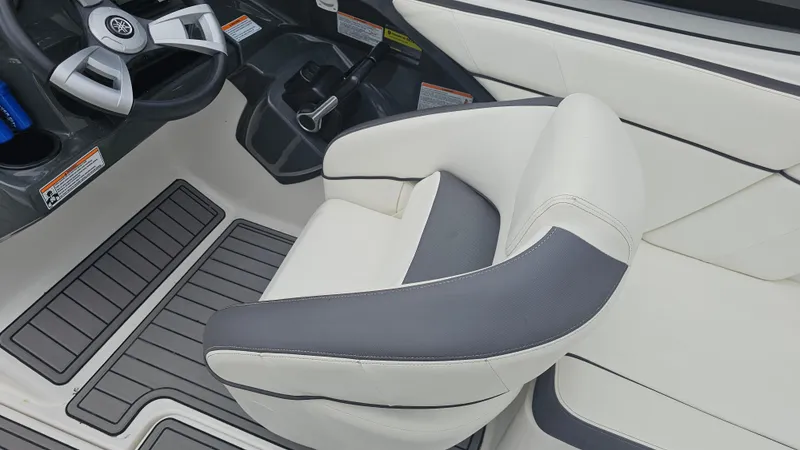 Slide: The Image of 2014 Yamaha AR210 boat interior with steering wheel and cushioned seating. - 15