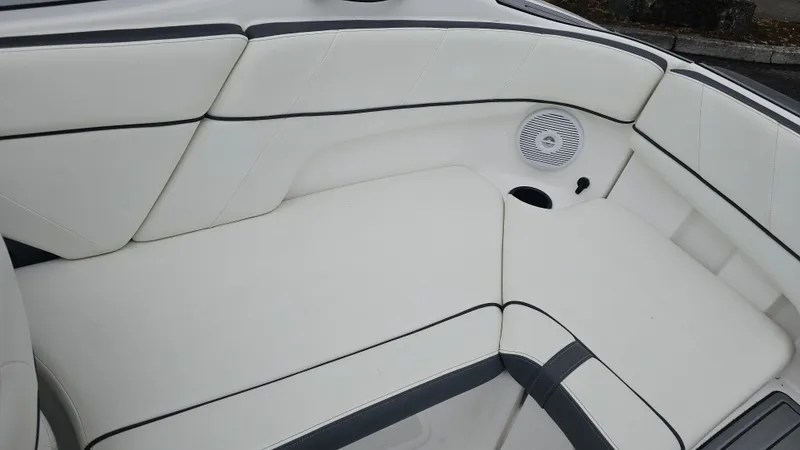 Slide: The Image of 2014 Yamaha AR210 boat interior with white cushioned seating and speaker. - 16
