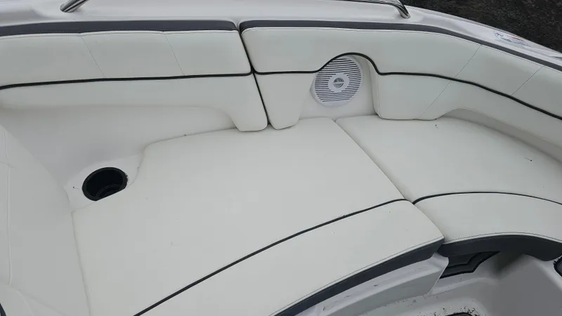 Slide: The Image of 2014 Yamaha AR210 boat interior with white cushioned seating and speaker. - 17