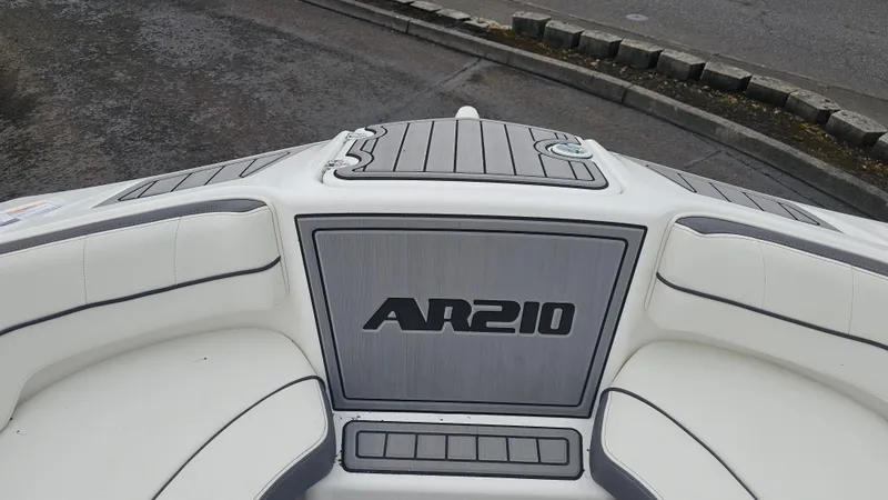 Slide: The Image of 2014 Yamaha Boats AR210 interior with sleek seating and AR210 logo. - 18