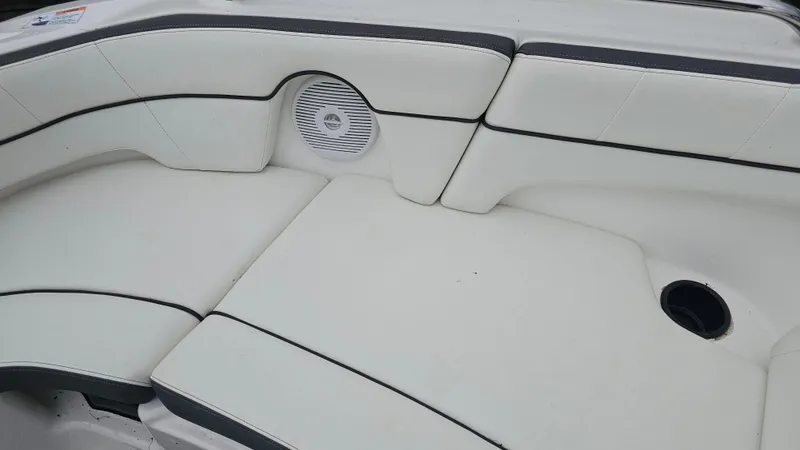 Slide: The Image of 2014 Yamaha AR210 boat interior with white cushioned seating and speaker. - 19