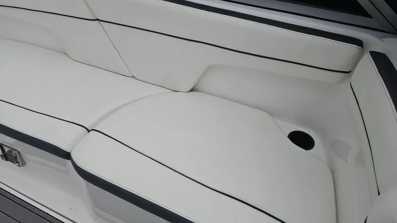 Slide: The Image of White seating area on a 2014 Yamaha AR210 boat with black trim. - 20