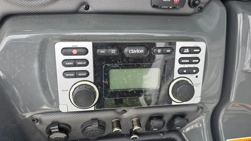 Slide: The Image of Control panel of a 2014 Yamaha Boats AR210 featuring a Clarion audio system. - 23
