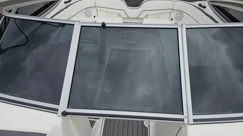 Slide: The Image of 2014 Yamaha AR210 boat with glass windshield and white interior seating. - 25