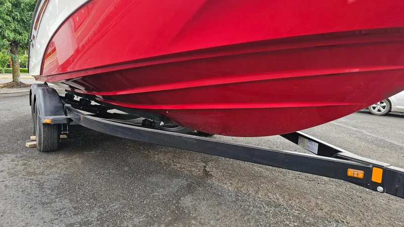Slide: The Image of Red 2014 Yamaha AR210 boat on trailer, parked on asphalt. - 28