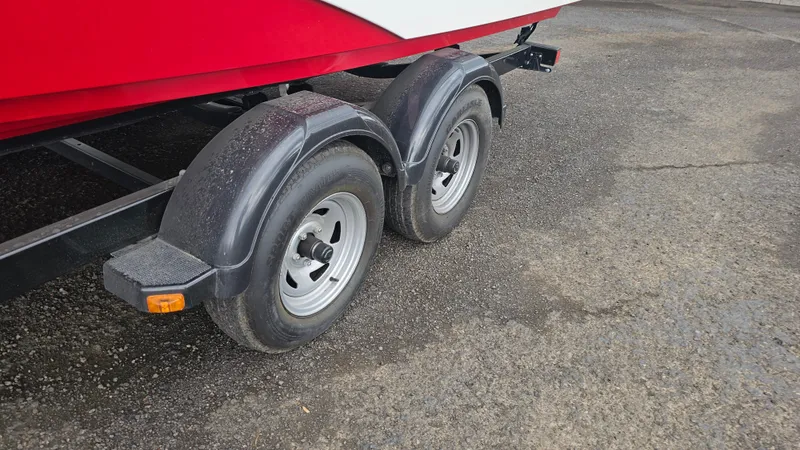 Slide: The Image of Trailer wheels of a 2014 Yamaha Boats AR210 on asphalt surface. - 29