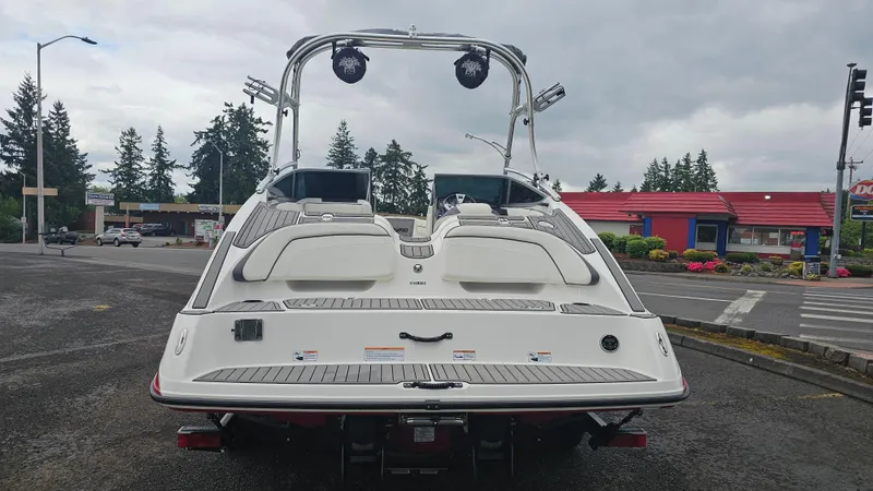 Slide: The Image of 2014 Yamaha AR210 boat, rear view, parked outdoors with overcast sky. - 7