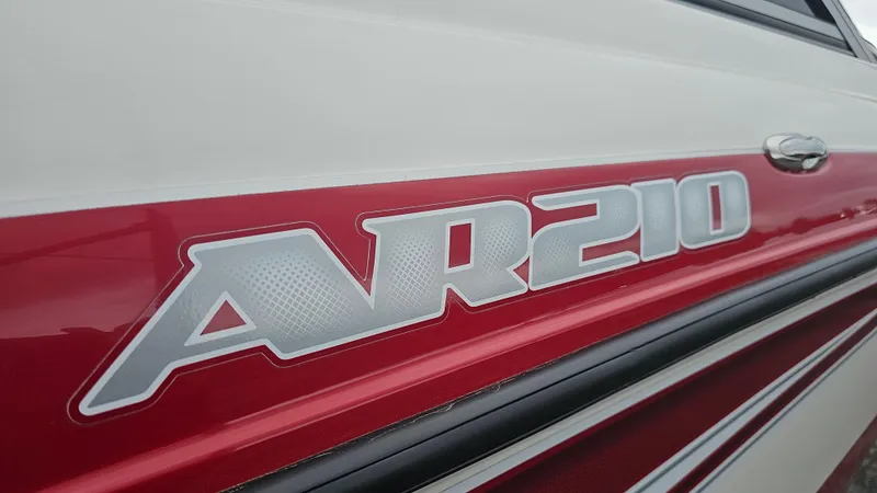 Slide: The Image of 2014 Yamaha Boats AR210 logo on red and white exterior. - 9