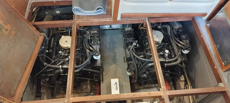 Slide: The Image of 1990 Carver 3607 Aft Cabin engine room with dual engines visible. - 10