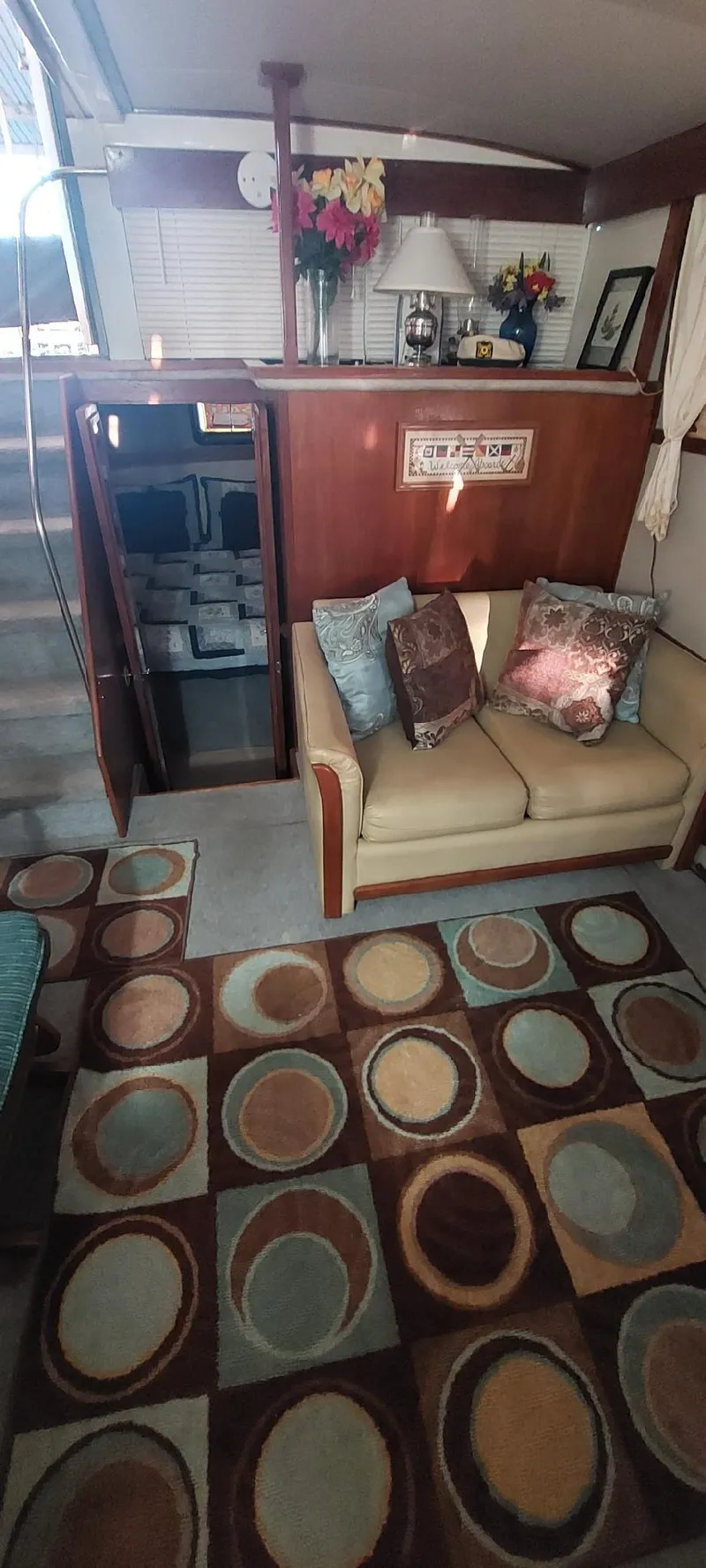 Slide: The Image of 1990 Carver 3607 Aft Cabin interior with cozy seating and patterned rug. - 5