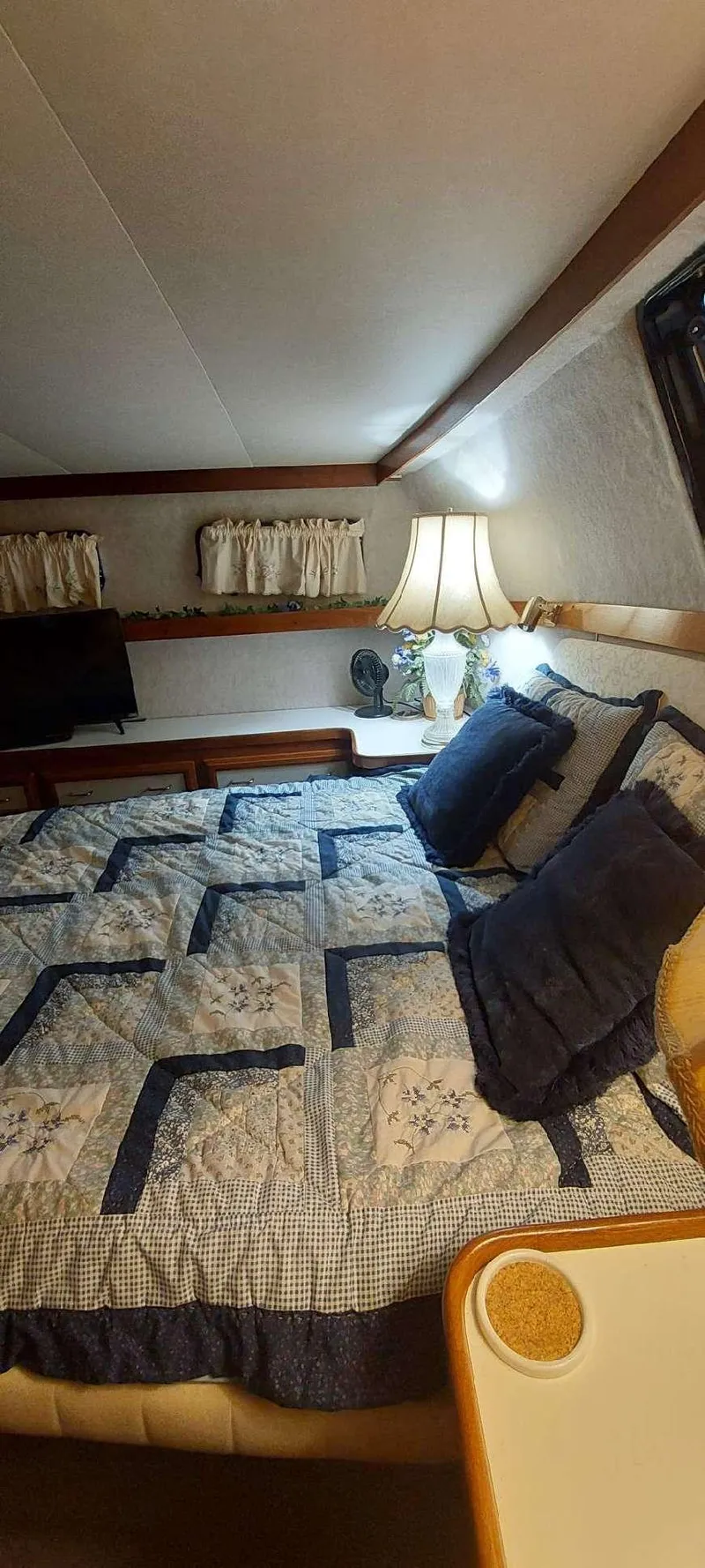 Slide: The Image of Cozy bedroom in 1990 Carver 3607 Aft Cabin with quilted bedding and soft lighting. - 6