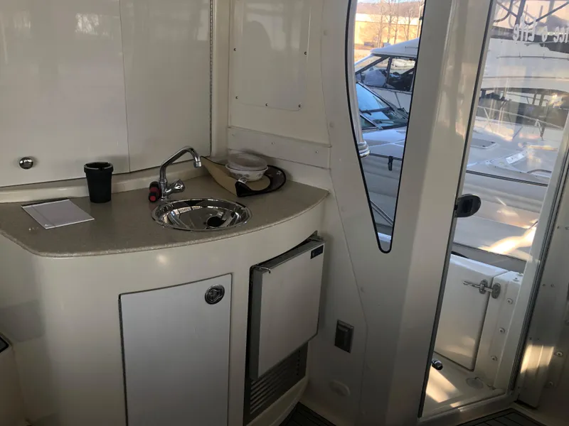 Slide: The Image of 2006 Carver 43 Motor Yacht interior with kitchenette and sink. - 13